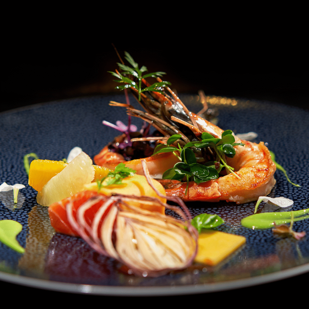 A plate with a shrimp and orange segments and watercress on top